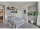 Cozy bedroom featuring shelves with plants, books, and pictures, along with a full sized bed at 410 Acoma St # 515, Denver, CO 80204