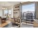 A sun-lit dining area and a balcony overlook the city at 410 Acoma St # 515, Denver, CO 80204