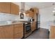Well-equipped kitchen showcasing stainless steel appliances, wooden cabinetry, and granite countertops at 410 Acoma St # 515, Denver, CO 80204