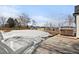 Large backyard with patio and a hot tub in a snowy setting at 6725 Beech Ct, Arvada, CO 80004