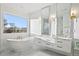 The bright bathroom has mountain views, a soaking tub, dual vanities, and modern fixtures at 6725 Beech Ct, Arvada, CO 80004