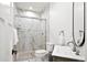 Stylish bathroom with a glass-enclosed shower featuring marble tiling, modern fixtures, and a sleek vanity at 6725 Beech Ct, Arvada, CO 80004