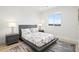 Bright bedroom featuring a modern platform bed, stylish nightstands, and a large window with a view at 6725 Beech Ct, Arvada, CO 80004