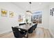 This dining room features a modern light fixture, a large window, and stylish seating at 6725 Beech Ct, Arvada, CO 80004