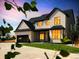 Stunning two-story home with a modern design, black trim, dark garage door, and a lush green lawn under a colorful sky at 6725 Beech Ct, Arvada, CO 80004