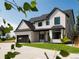 Two-story modern home with white exterior, black accents, and a two-car garage at 6725 Beech Ct, Arvada, CO 80004