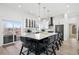 Modern eat-in kitchen boasts white cabinets, stainless appliances, large island and access to a balcony at 6725 Beech Ct, Arvada, CO 80004