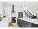 Modern kitchen featuring white and dark gray cabinetry, a large island, and stainless steel appliances at 6725 Beech Ct, Arvada, CO 80004