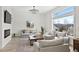 Spacious living room with large windows, wood floors, fireplace, and comfortable seating at 6725 Beech Ct, Arvada, CO 80004