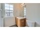 Bright bathroom with a window, single sink vanity, and toilet at 19213 E Idaho Dr # 105, Aurora, CO 80017