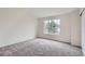 Carpeted bedroom with a large window for natural light and a sliding-door closet at 19213 E Idaho Dr # 105, Aurora, CO 80017