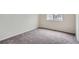 Carpeted bedroom with a large window overlooking the neighborhood at 19213 E Idaho Dr # 105, Aurora, CO 80017