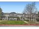 Attractive townhomes with blue and gray siding, manicured lawns, and steps leading to front doors at 19213 E Idaho Dr # 105, Aurora, CO 80017
