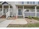 Charming townhome featuring a welcoming front porch with a blue door and well-maintained landscaping at 19213 E Idaho Dr # 105, Aurora, CO 80017