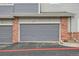 Attached one car garage with brick accents and the number 105 above the door at 19213 E Idaho Dr # 105, Aurora, CO 80017