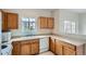 Well-maintained kitchen featuring wood cabinets, a double sink, and a bright window at 19213 E Idaho Dr # 105, Aurora, CO 80017