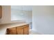 Open kitchen featuring wood cabinets and a breakfast bar overlooking the living area at 19213 E Idaho Dr # 105, Aurora, CO 80017