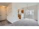 Bright living room with neutral carpet and sliding glass doors to the outside patio at 19213 E Idaho Dr # 105, Aurora, CO 80017