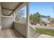 Relaxing outdoor patio with wood floors and views of the parking lot and lawn at 19213 E Idaho Dr # 105, Aurora, CO 80017