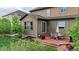Backyard patio with dining set, landscaped garden, and well-maintained lawn at 7465 Grady Cir, Castle Rock, CO 80108