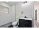 Modern bathroom featuring a dark vanity with a walk-in shower and sleek fixtures at 6882 Quail St, Arvada, CO 80004