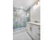 Modern bathroom features luxury tile shower with custom glass and double vanity at 6882 Quail St, Arvada, CO 80004