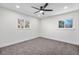 Bright bedroom featuring carpeted floors, a modern ceiling fan, and large windows for ample natural light at 6882 Quail St, Arvada, CO 80004