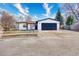 Charming single-story home features stucco and stone accents, a well-manicured lawn, and a spacious two-car garage at 6882 Quail St, Arvada, CO 80004