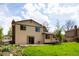 Backyard with a well-maintained lawn, mature trees, and garden beds at 11131 W Oregon Pl, Lakewood, CO 80232
