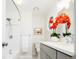 A stylish bathroom featuring modern fixtures, decorative flower arrangement, and framed art that adds an elegant touch at 11131 W Oregon Pl, Lakewood, CO 80232