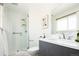 Modern bathroom featuring a glass-enclosed shower, sleek vanity, and neutral finishes at 11131 W Oregon Pl, Lakewood, CO 80232