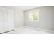 This bedroom features neutral colors, a window offering natural light, and a spacious closet for optimal storage at 11131 W Oregon Pl, Lakewood, CO 80232