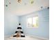Adorable bedroom with light blue walls, playful decor, and ample natural light at 11131 W Oregon Pl, Lakewood, CO 80232