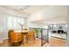 Cozy dining area boasts modern chairs, hardwood floors, large windows, and an open layout at 11131 W Oregon Pl, Lakewood, CO 80232