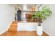 Welcoming entryway with hardwood floors and view into the dining area, with a stylish plant feature at 11131 W Oregon Pl, Lakewood, CO 80232