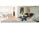 Stylish living room with hardwood floors, modern furniture, open layout, and staircase access to upper level at 11131 W Oregon Pl, Lakewood, CO 80232