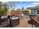 Backyard with a deck featuring a stock tank pool, lounge seating, and privacy fence at 11031 Marshall St, Westminster, CO 80020