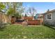 Beautifully landscaped backyard featuring a built-in hot tub and deck area, perfect for relaxation at 11031 Marshall St, Westminster, CO 80020