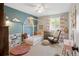 Well decorated bedroom featuring a modern house frame bed, rocking chair, and bright blue accent wall at 11031 Marshall St, Westminster, CO 80020