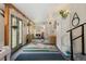 Bright and airy bonus room featuring a geometric rug, white walls, exercise equipment and lots of natural light at 11031 Marshall St, Westminster, CO 80020
