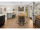 Eat-in kitchen features an island with a butcher block countertop, dining table and natural light at 11031 Marshall St, Westminster, CO 80020
