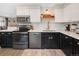 Well lit kitchen featuring a stainless steel oven, dishwasher and a sleek black and white color palette at 11031 Marshall St, Westminster, CO 80020