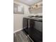 Convenient laundry room with modern washer and dryer, stylish tile flooring and storage shelves at 11031 Marshall St, Westminster, CO 80020