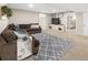 Basement living room with plush seating, accent rug, and entertainment center at 11031 Marshall St, Westminster, CO 80020