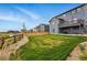 The backyard features a well-manicured lawn, wooden fence and neighboring houses at 11744 Magnolia Dr, Thornton, CO 80233