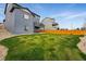 The wide backyard provides privacy, showcasing the lush lawn and well-designed home exterior at 11744 Magnolia Dr, Thornton, CO 80233