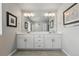Bright bathroom with double vanity, ample storage, and modern fixtures at 11744 Magnolia Dr, Thornton, CO 80233