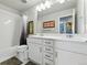 Bright bathroom features a double sink vanity, granite countertops, and a shower-tub combo at 11744 Magnolia Dr, Thornton, CO 80233