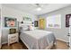 Cozy bedroom showcasing hardwood floors, a ceiling fan and a large window to allow natural light at 11744 Magnolia Dr, Thornton, CO 80233