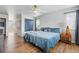 Comfortable bedroom featuring a large window for natural light and wood flooring at 11744 Magnolia Dr, Thornton, CO 80233